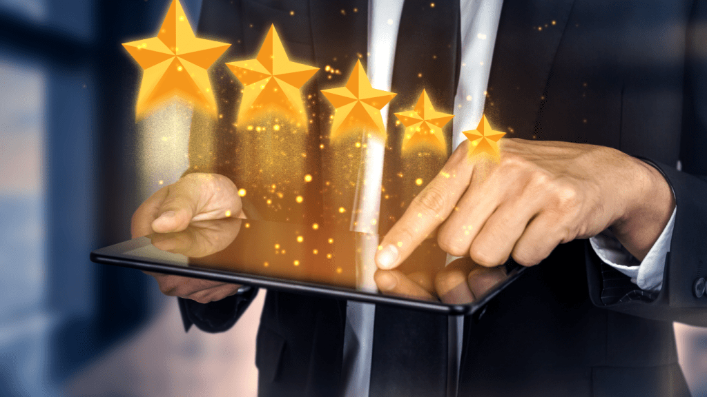 A tablet in a man’s hand with 5 stars popping up, symbolizing excellent ratings