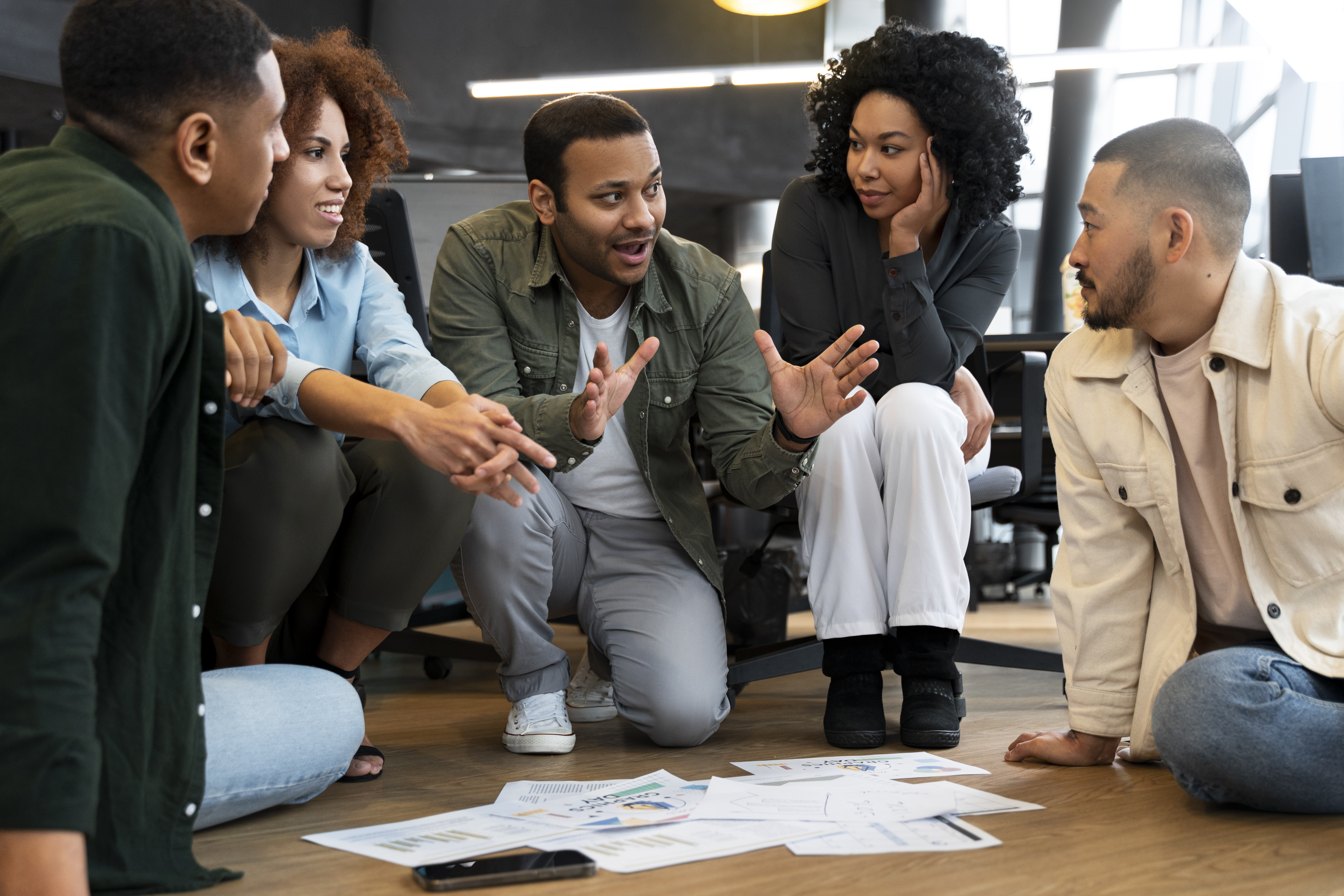 A group of corporate workers collaborating and brainstorming ideas in an office setting