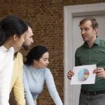 A group of corporate workers collaborating and brainstorming ideas in an office setting